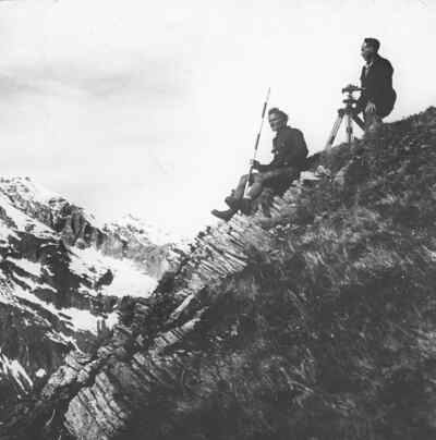 Two surveyors sitting on a rock