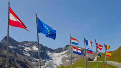 Flags wave in the wind in front of the Grossglockner